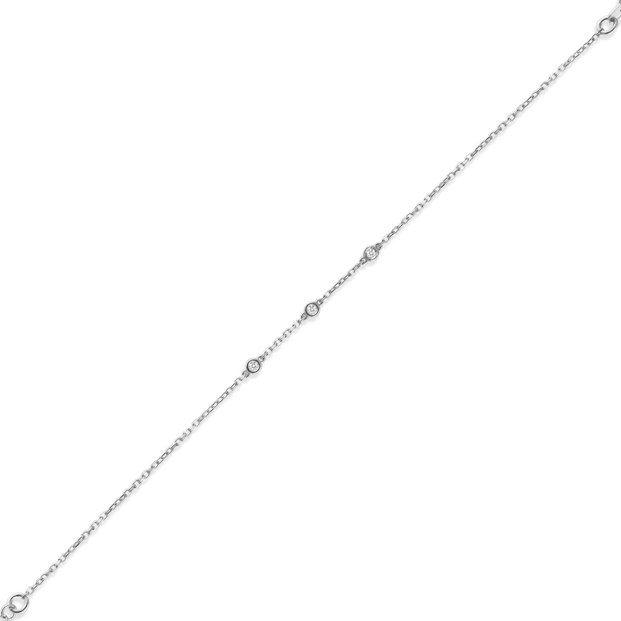 Arel Custom Jewelry 14k solid gold dainty station bracelet featuring three bezel set natural diamonds on a model's wrist