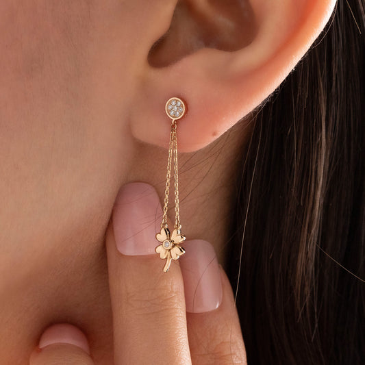 Arel Custom Jewelry 14k solid gold dangle earring with a pave diamond stud and double chain clover drop on a model.