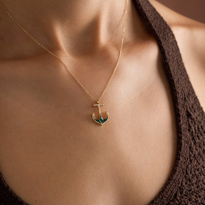 Arel Custom Jewelry 14k solid gold necklace featuring a nautical anchor pendant with green enamel and pave diamonds on a model.