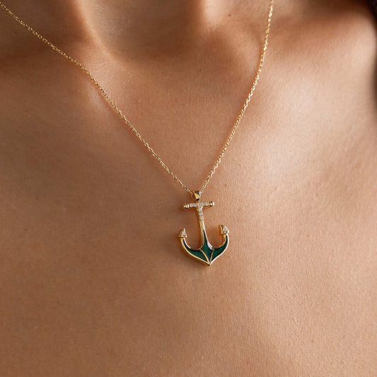 Arel Custom Jewelry 14k solid gold necklace featuring a nautical anchor pendant with green enamel and pave diamonds on a model.