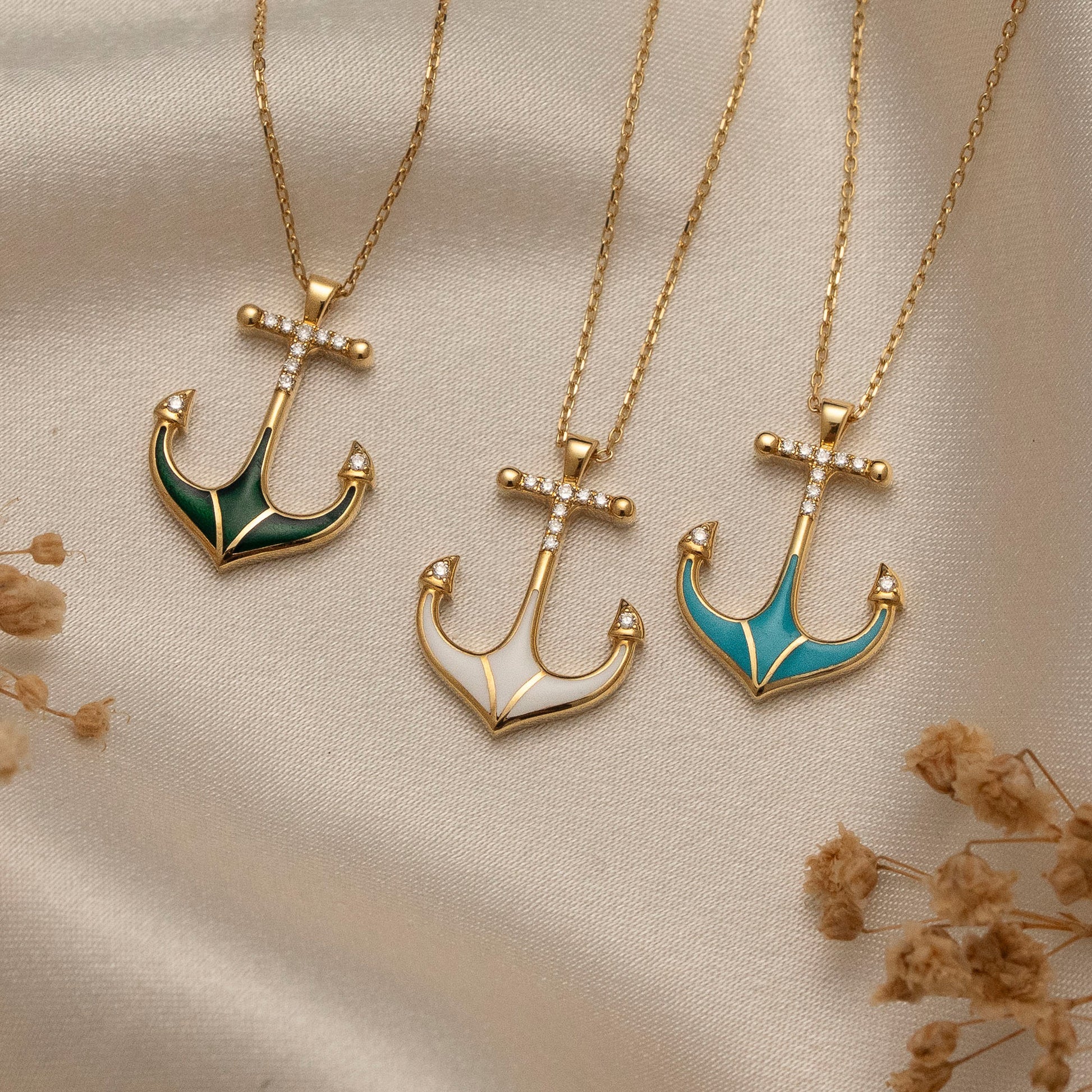 Arel Custom Jewelry 14k solid gold necklace featuring a nautical anchor pendant with green enamel and pave diamonds on a model.