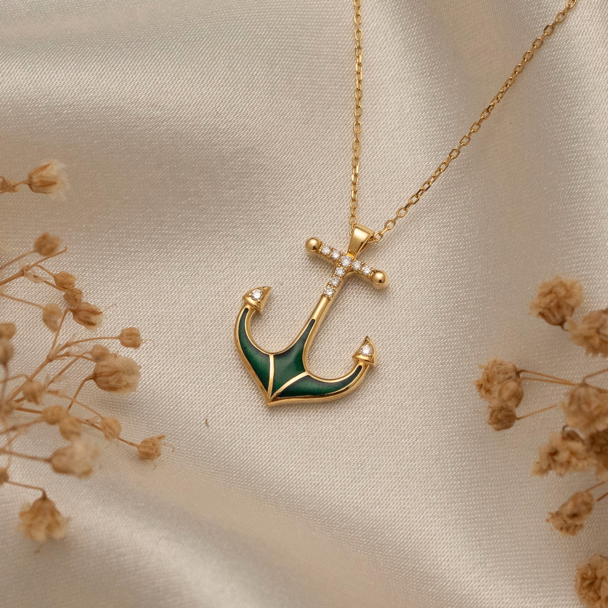 Arel Custom Jewelry 14k solid gold necklace featuring a nautical anchor pendant with green enamel and pave diamonds on a model.