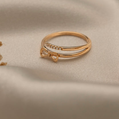 Arel Custom Jewelry 14k solid gold double band wrap ring featuring a polished bow and a pave diamond row on a model's finger.