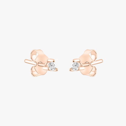 14k solid gold 3 prong diamond stud earrings featuring 2.20mm stones in rose, yellow, and white gold on a model's ear.