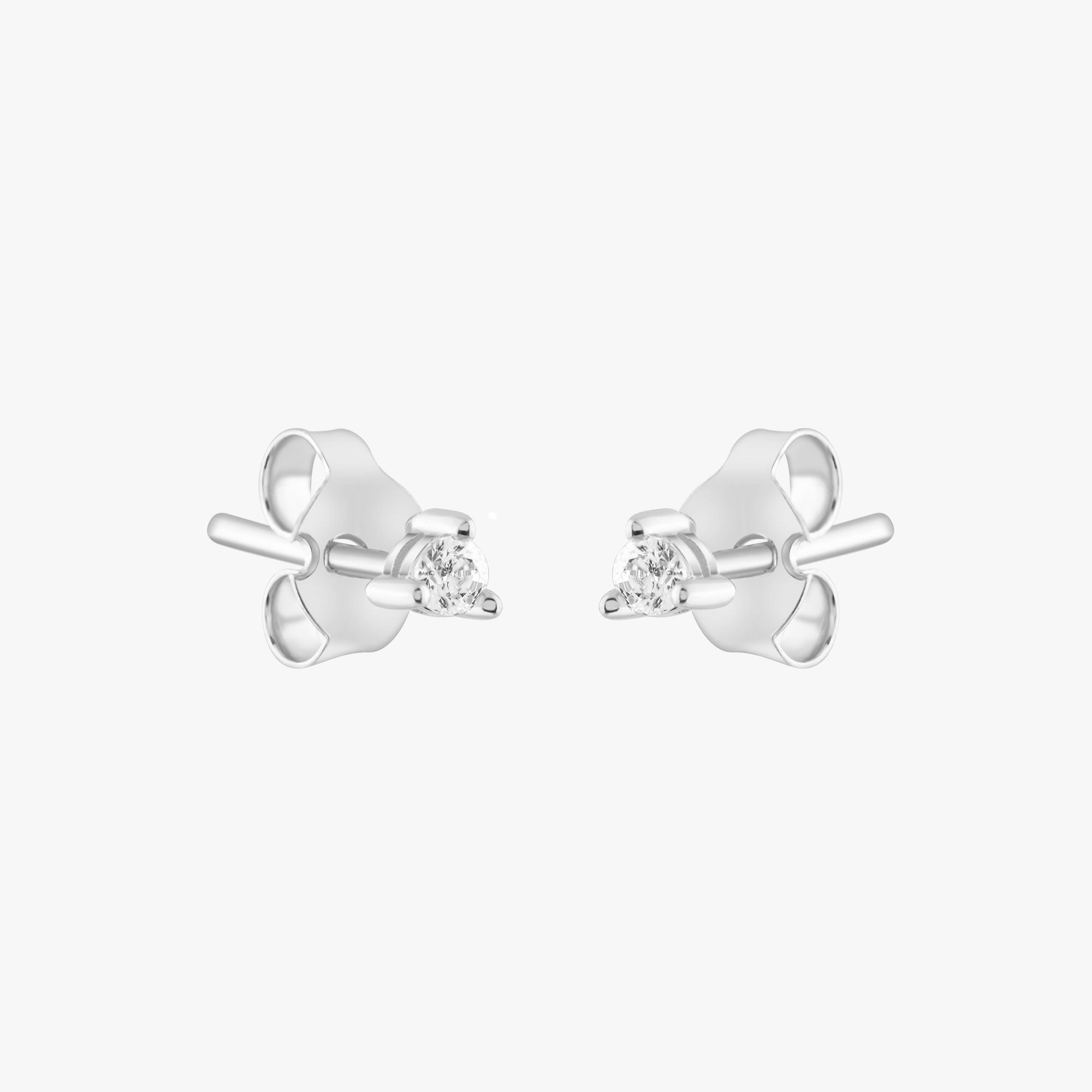 14k solid gold 3 prong diamond stud earrings featuring 2.20mm stones in rose, yellow, and white gold on a model's ear.