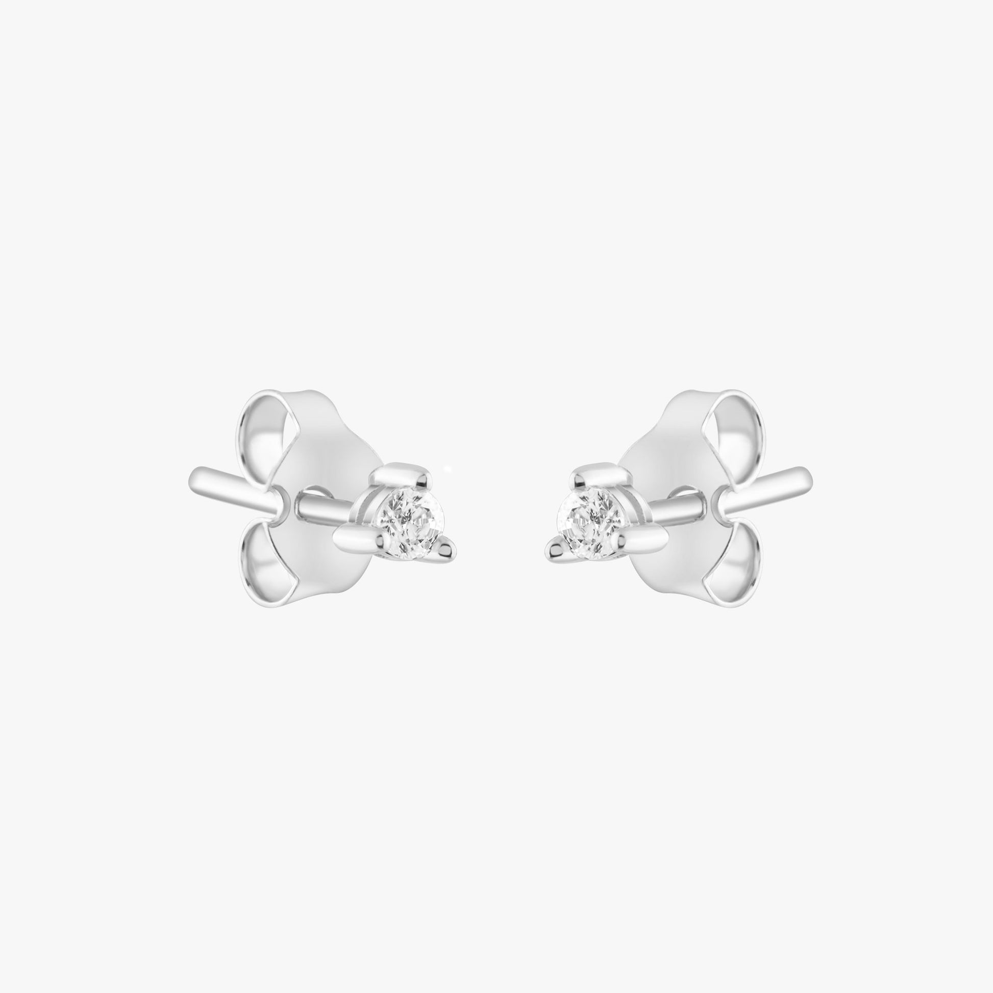 14k solid gold 3 prong diamond stud earrings featuring 2.20mm stones in rose, yellow, and white gold on a model's ear.