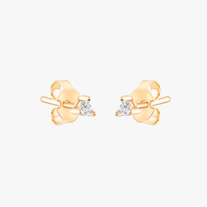 14k solid gold 3 prong diamond stud earrings featuring 2.20mm stones in rose, yellow, and white gold on a model's ear.