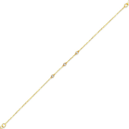 Arel Custom Jewelry 14k solid gold dainty station bracelet featuring three bezel set natural diamonds on a model's wrist