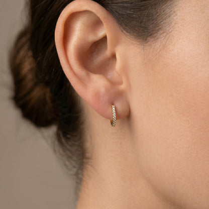 Arel Custom Jewelry 14k solid white gold huggie hoop earrings featuring pave set diamonds, measuring 8mm inner diameter and 11mm outer diameter.