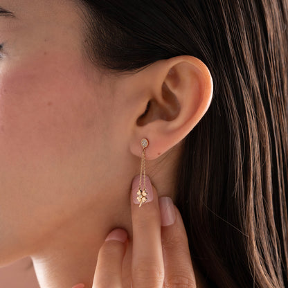 Arel Custom Jewelry 14k solid gold dangle earring with a pave diamond stud and double chain clover drop on a model.