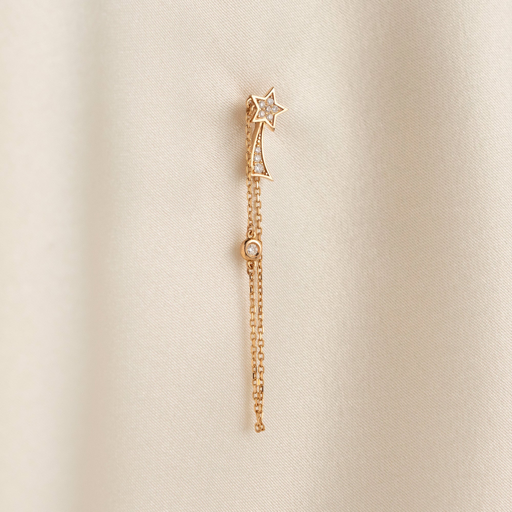Arel Custom Jewelry 14k solid gold North Star earring with natural diamonds and a shooting star tail on model.