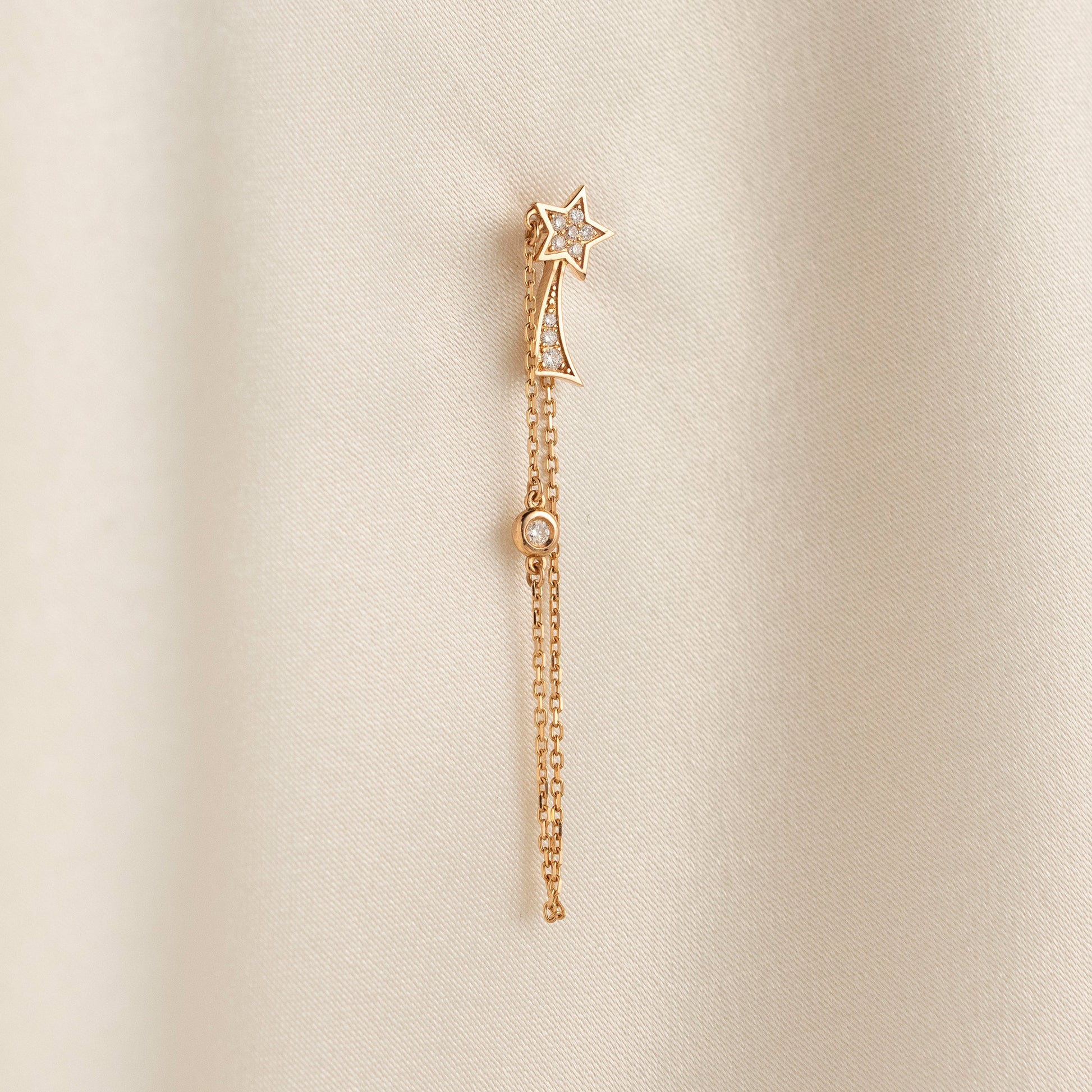Arel Custom Jewelry 14k solid gold North Star earring with natural diamonds and a shooting star tail on model.