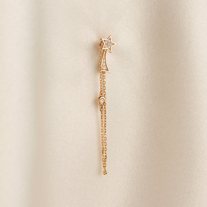 Arel Custom Jewelry 14k solid gold North Star earring with natural diamonds and a shooting star tail on model.