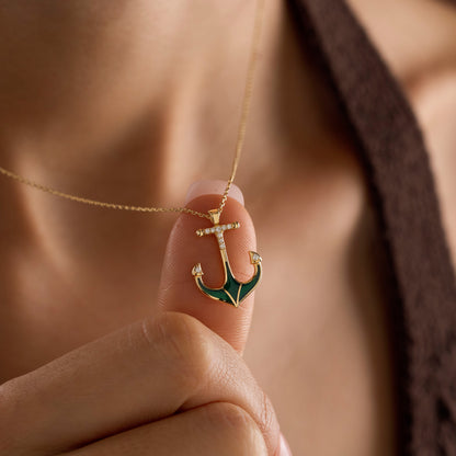 Arel Custom Jewelry 14k solid gold necklace featuring a nautical anchor pendant with green enamel and pave diamonds on a model.
