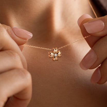 Arel Custom Jewelry 14k solid gold minimalist necklace featuring a four leaf clover pendant with a center diamond on a model.