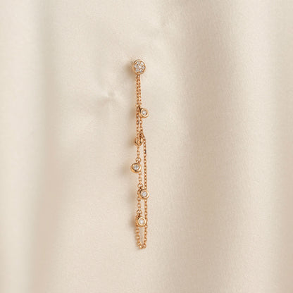 14k solid gold chain bezel earring featuring a round diamond stud and 5 diamond drops on a model.