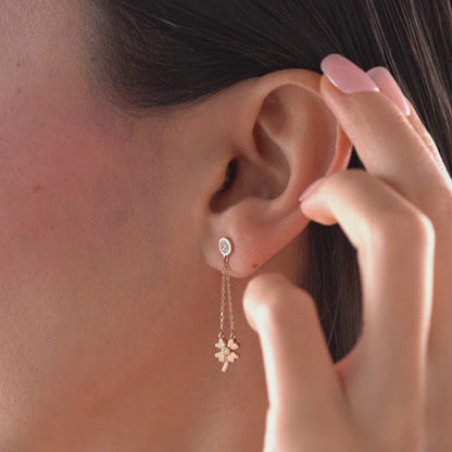 Arel Custom Jewelry 14k solid gold dangle earring with a pave diamond stud and double chain clover drop on a model.