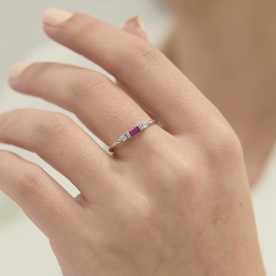 14k solid gold three stone ring featuring a 4x2mm center baguette gemstone and two 1.80mm round diamond accents on a model's hand.