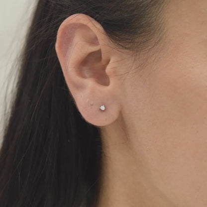 14k solid gold 3 prong diamond stud earrings featuring 2.20mm stones in rose, yellow, and white gold on a model's ear.