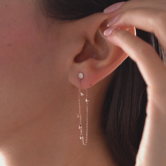 14k solid gold chain bezel earring featuring a round diamond stud and 5 diamond drops on a model.
