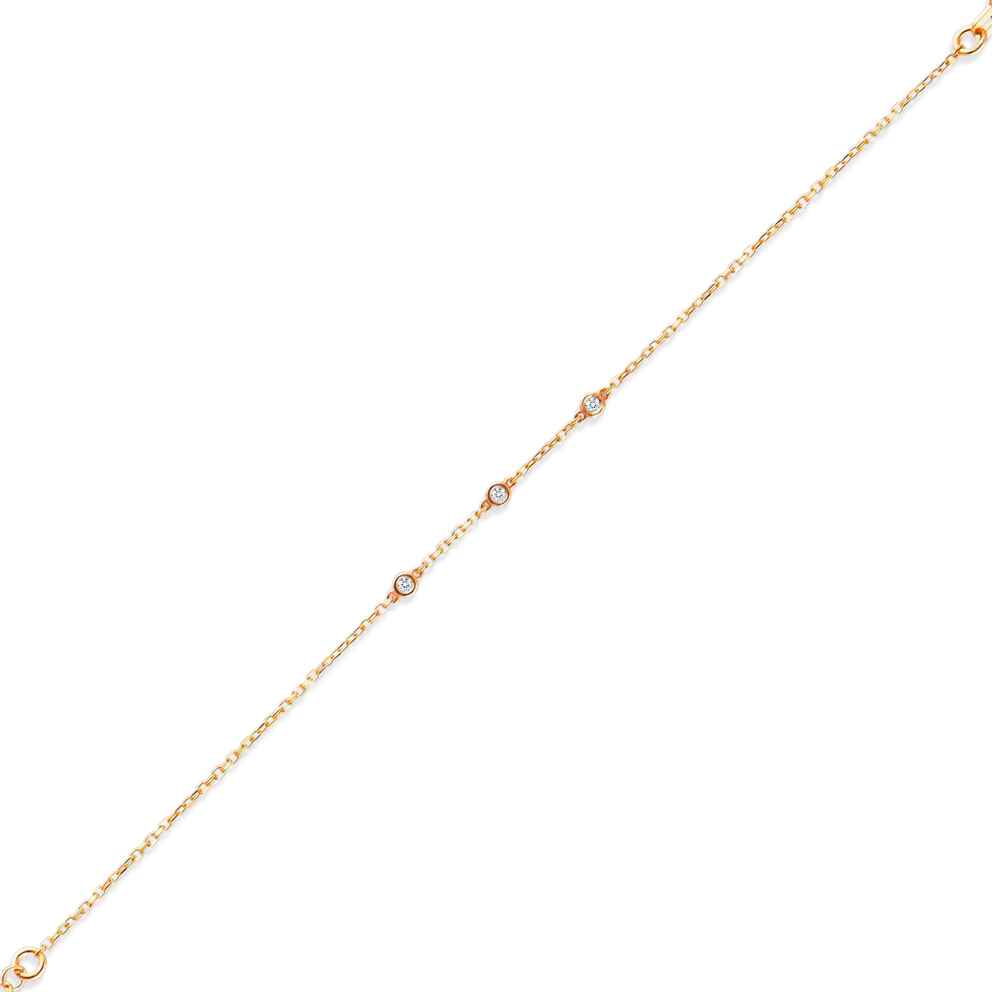 Arel Custom Jewelry 14k solid gold dainty station bracelet featuring three bezel set natural diamonds on a model's wrist