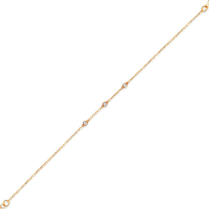 Arel Custom Jewelry 14k solid gold dainty station bracelet featuring three bezel set natural diamonds on a model's wrist