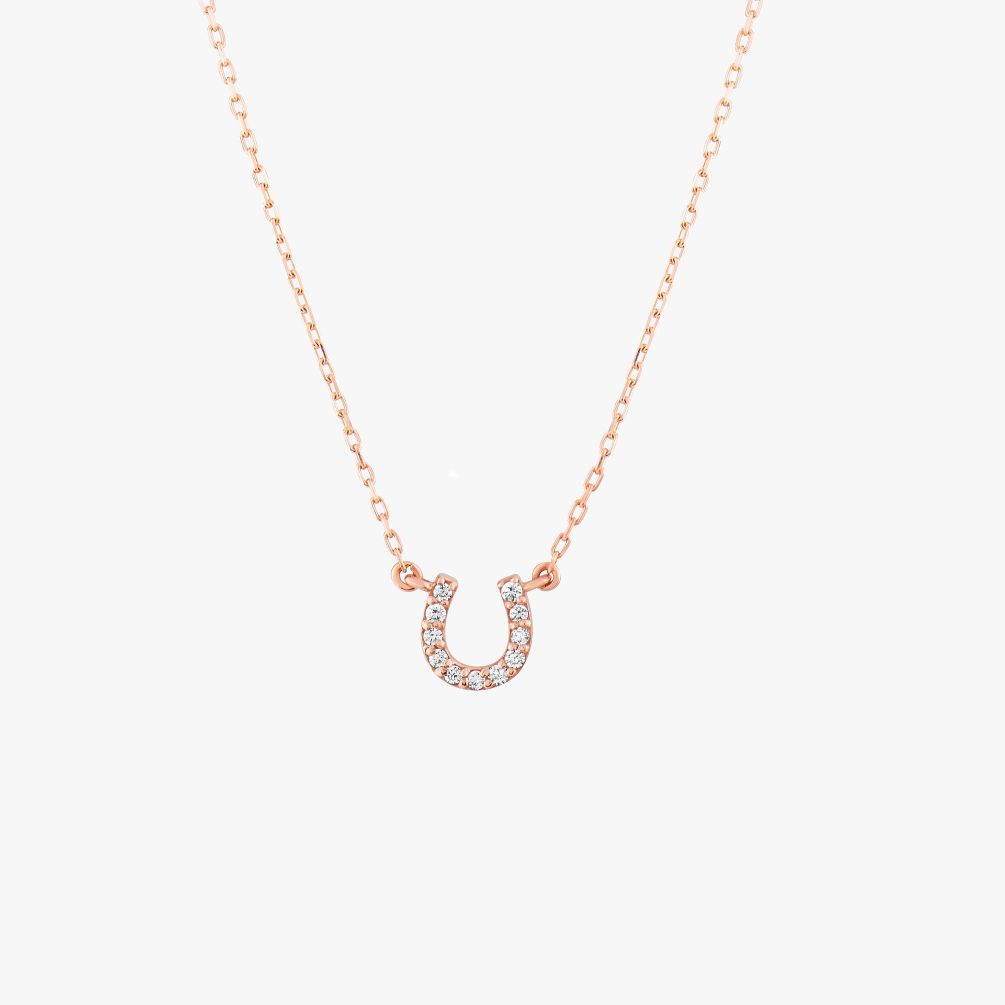Arel Custom Jewelry 14k solid gold dainty necklace featuring a stationary pave diamond horseshoe pendant on a model.