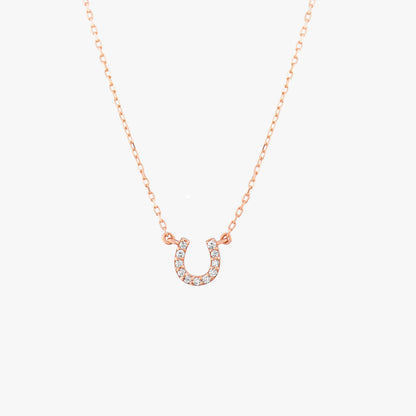 Arel Custom Jewelry 14k solid gold dainty necklace featuring a stationary pave diamond horseshoe pendant on a model.