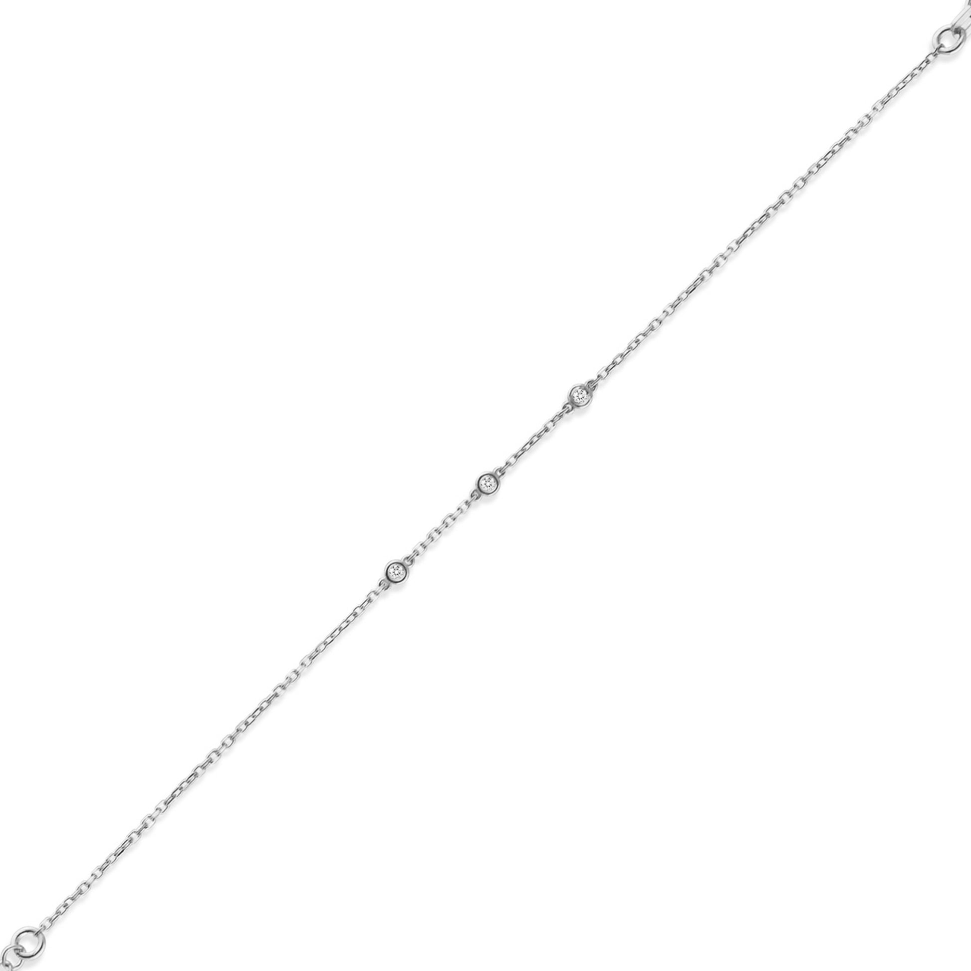 Arel Custom Jewelry 14k solid gold dainty station bracelet featuring three bezel set natural diamonds on a model's wrist