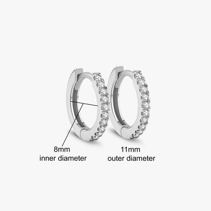 Arel Custom Jewelry 14k solid white gold huggie hoop earrings featuring pave set diamonds, measuring 8mm inner diameter and 11mm outer diameter.