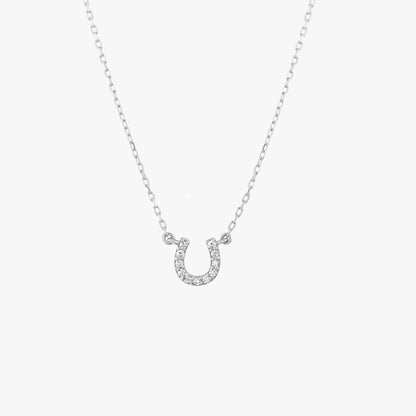 Arel Custom Jewelry 14k solid gold dainty necklace featuring a stationary pave diamond horseshoe pendant on a model.