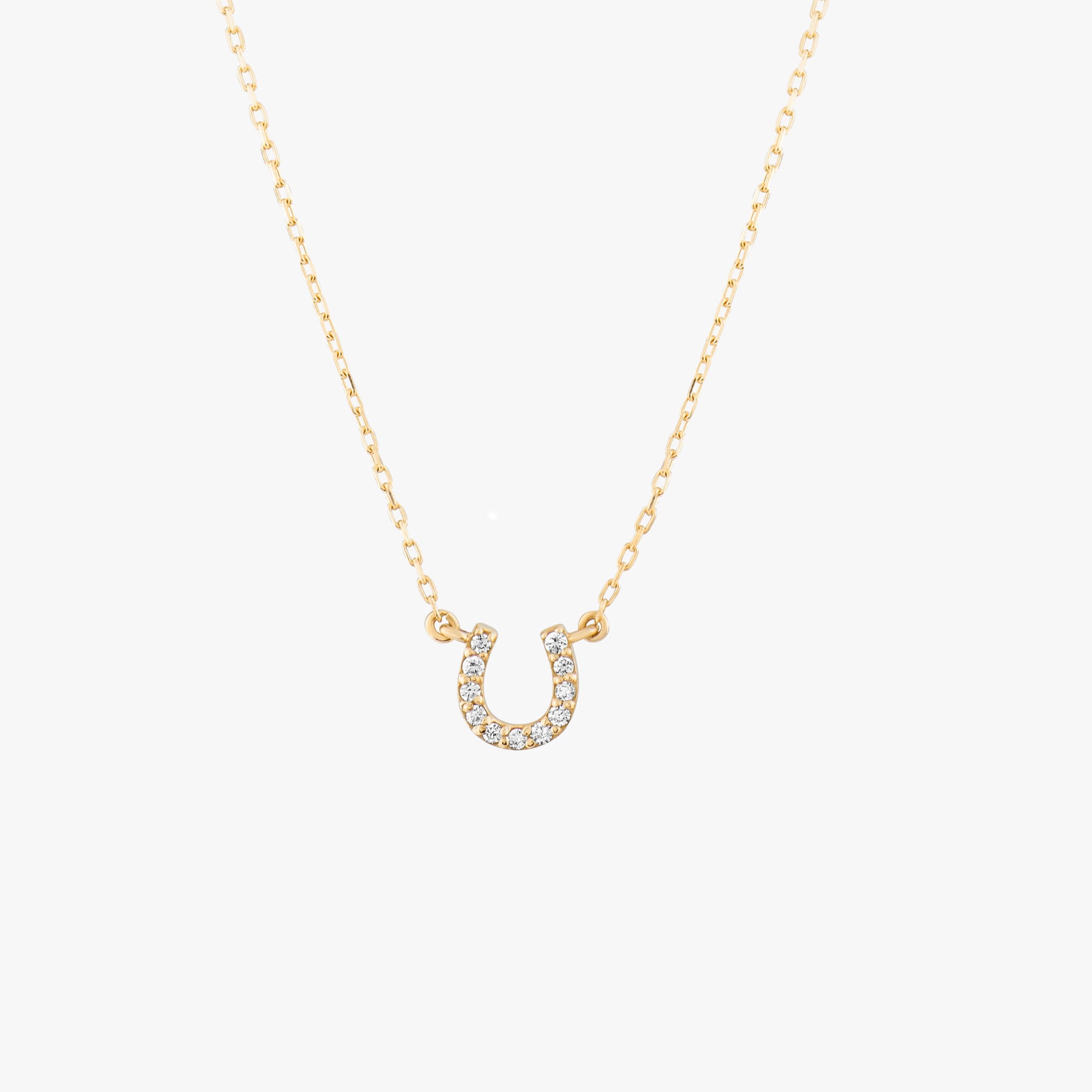 Arel Custom Jewelry 14k solid gold dainty necklace featuring a stationary pave diamond horseshoe pendant on a model.